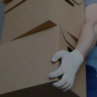 Mover pushing a cart with cardboard boxes